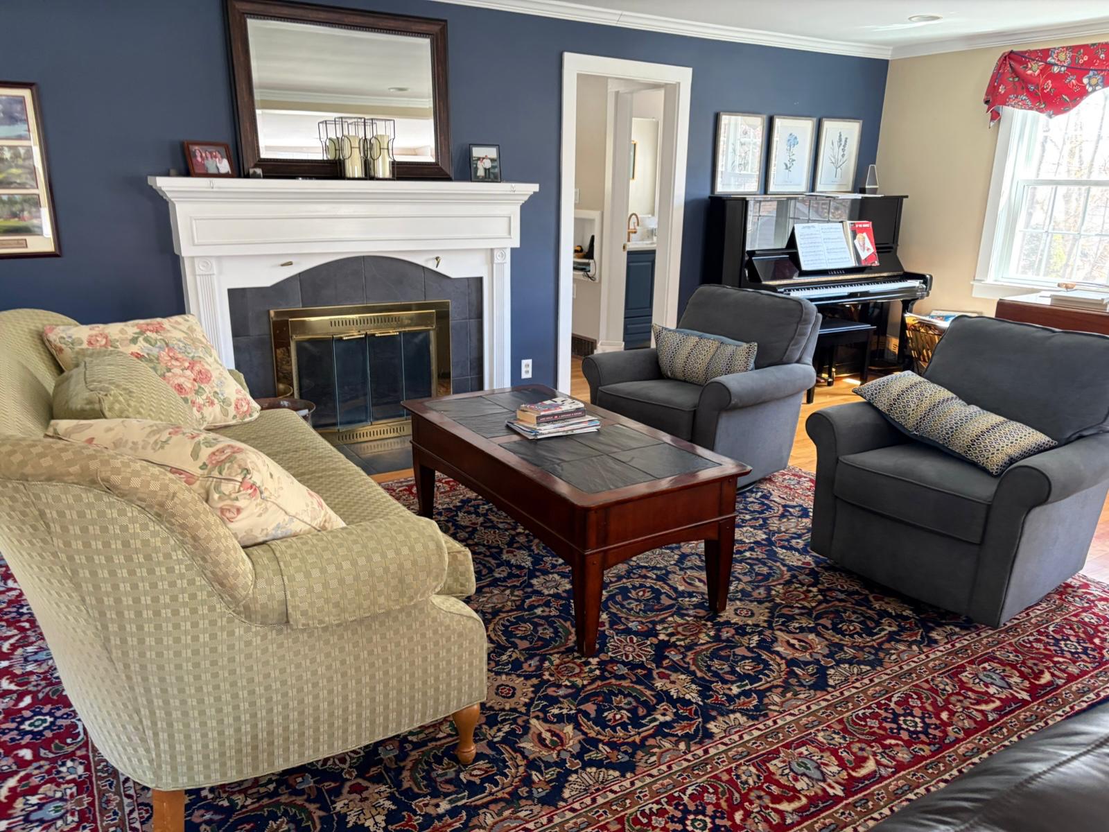 Carefully cleaned blue living room with fireplace and piano